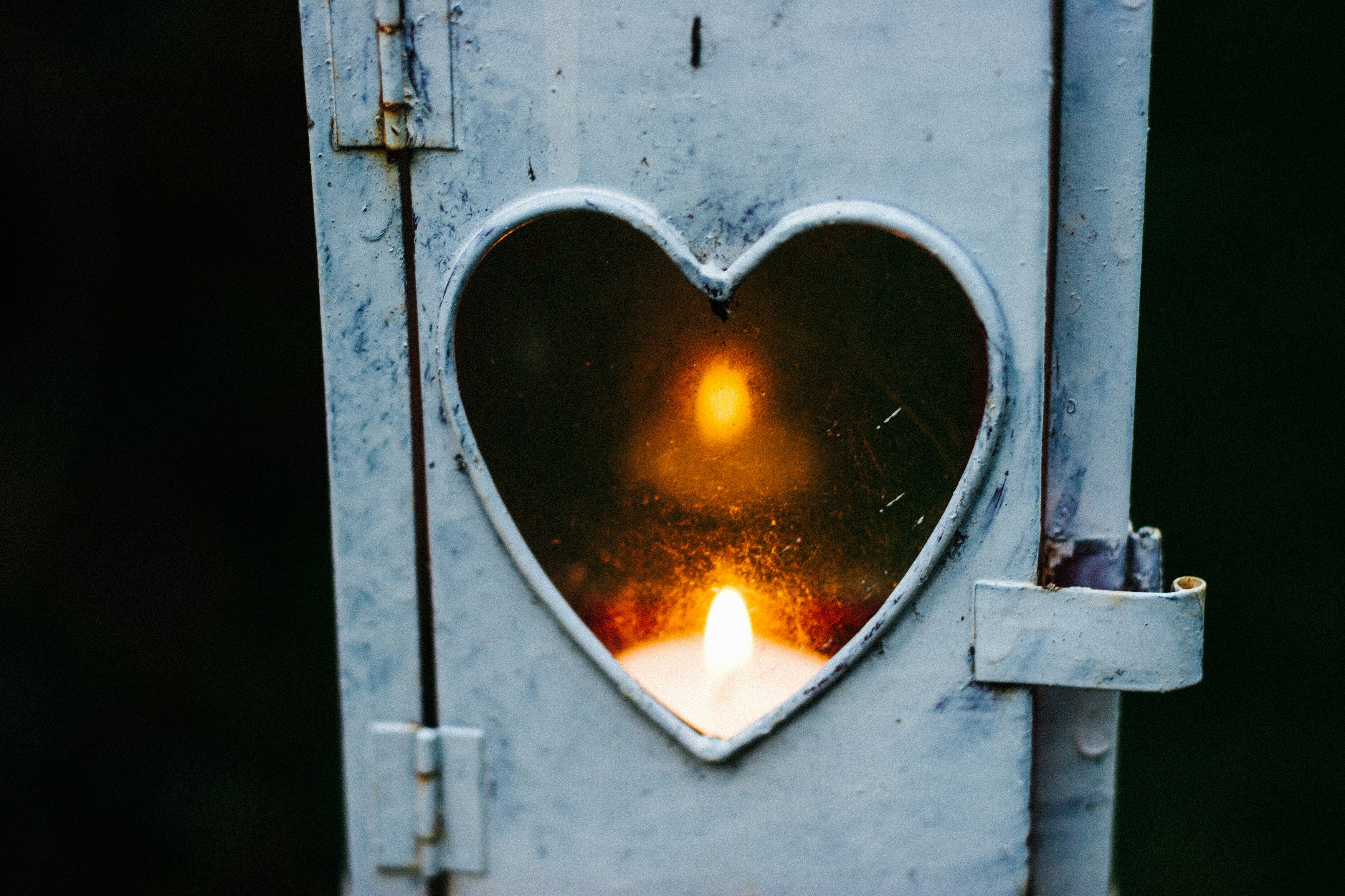 a heart-shaped window with a candle inside | financialtherapysolutions.com